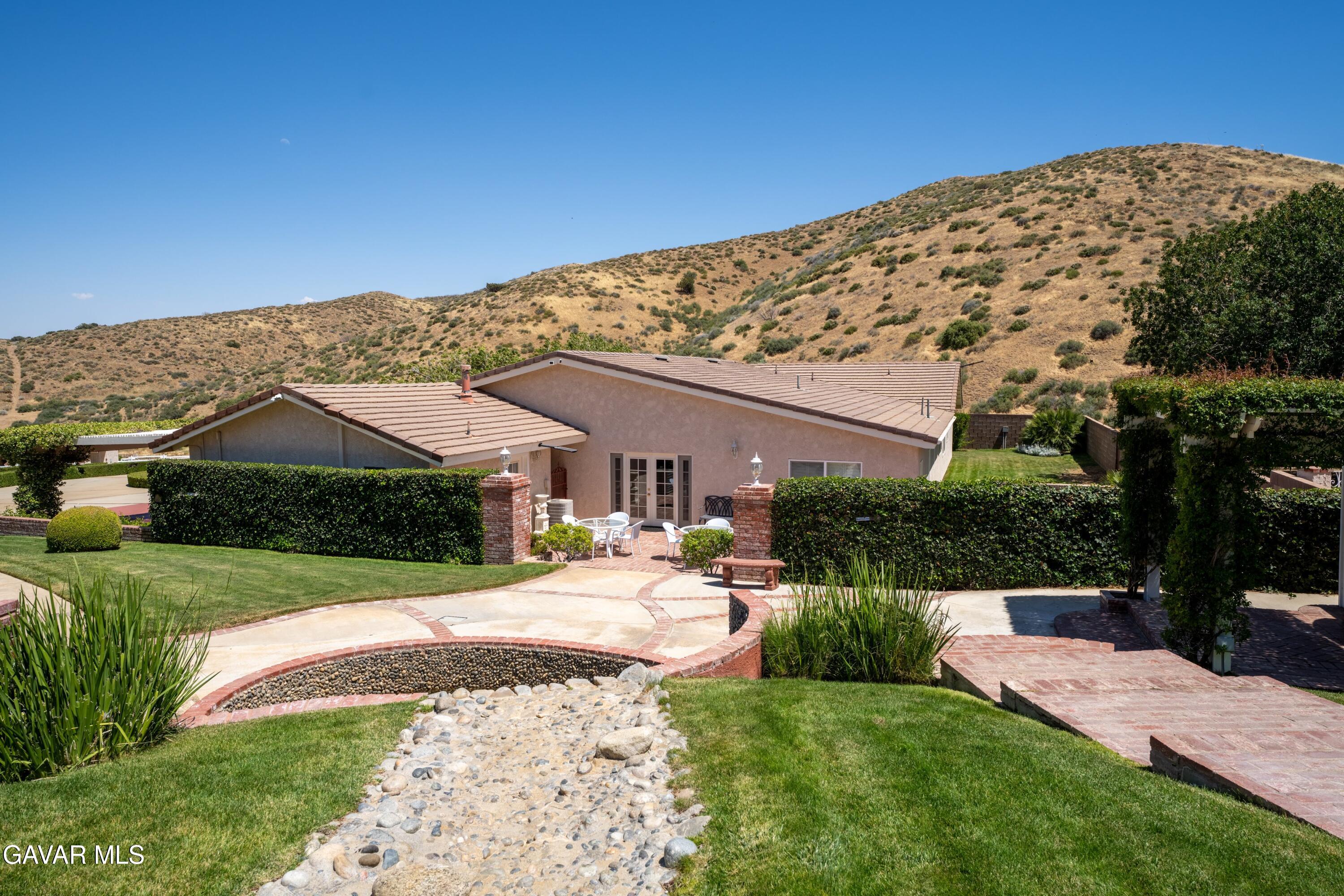 5801 Hacienda Ranch Road Palmdale, CA 93551 - Photo 60 of 69 a view of a house with a yard