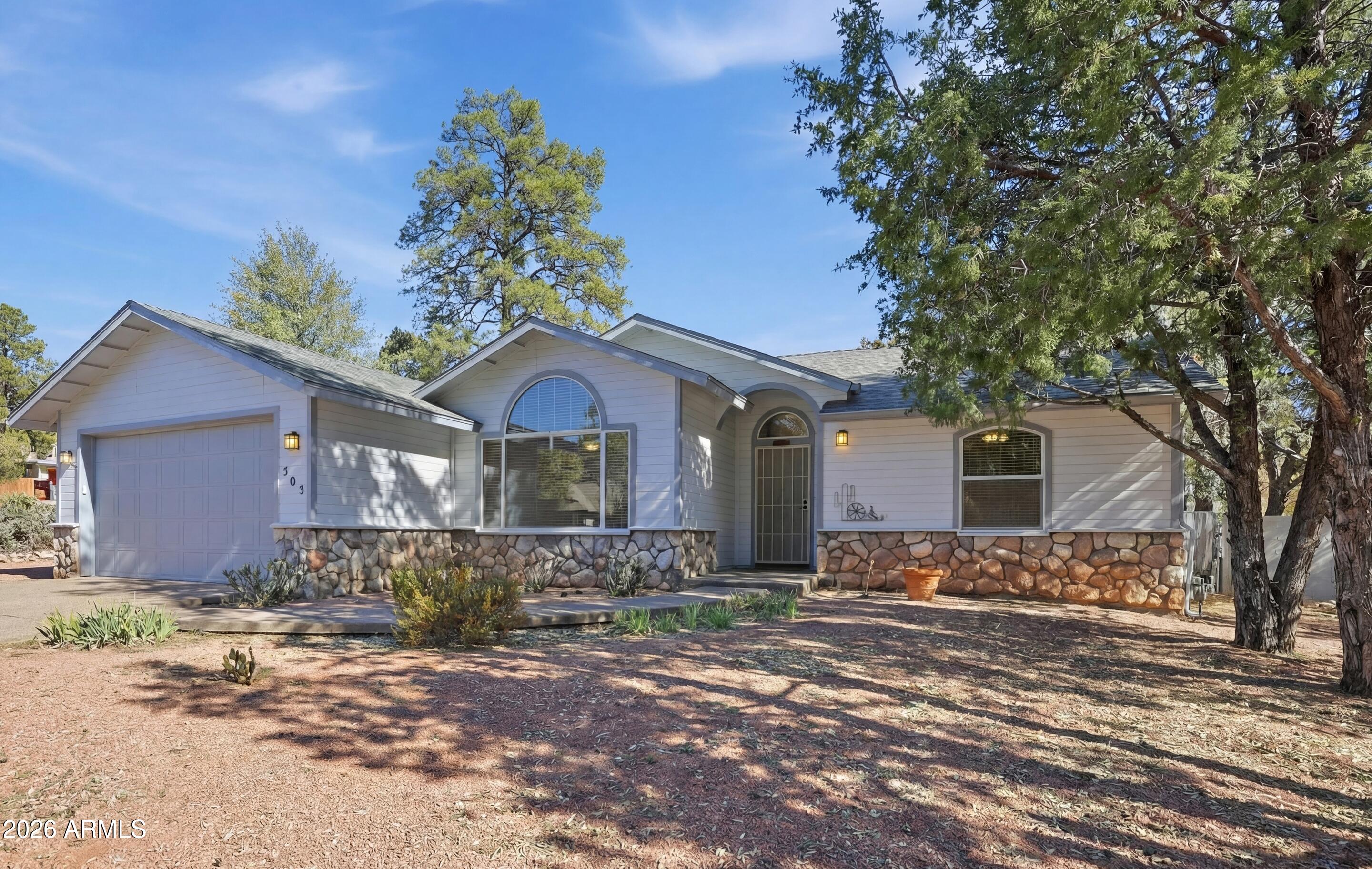 505 North Wood Hill Road Payson, AZ 85541 - Photo 1 of 26 a front view of a house with a yard and large tree