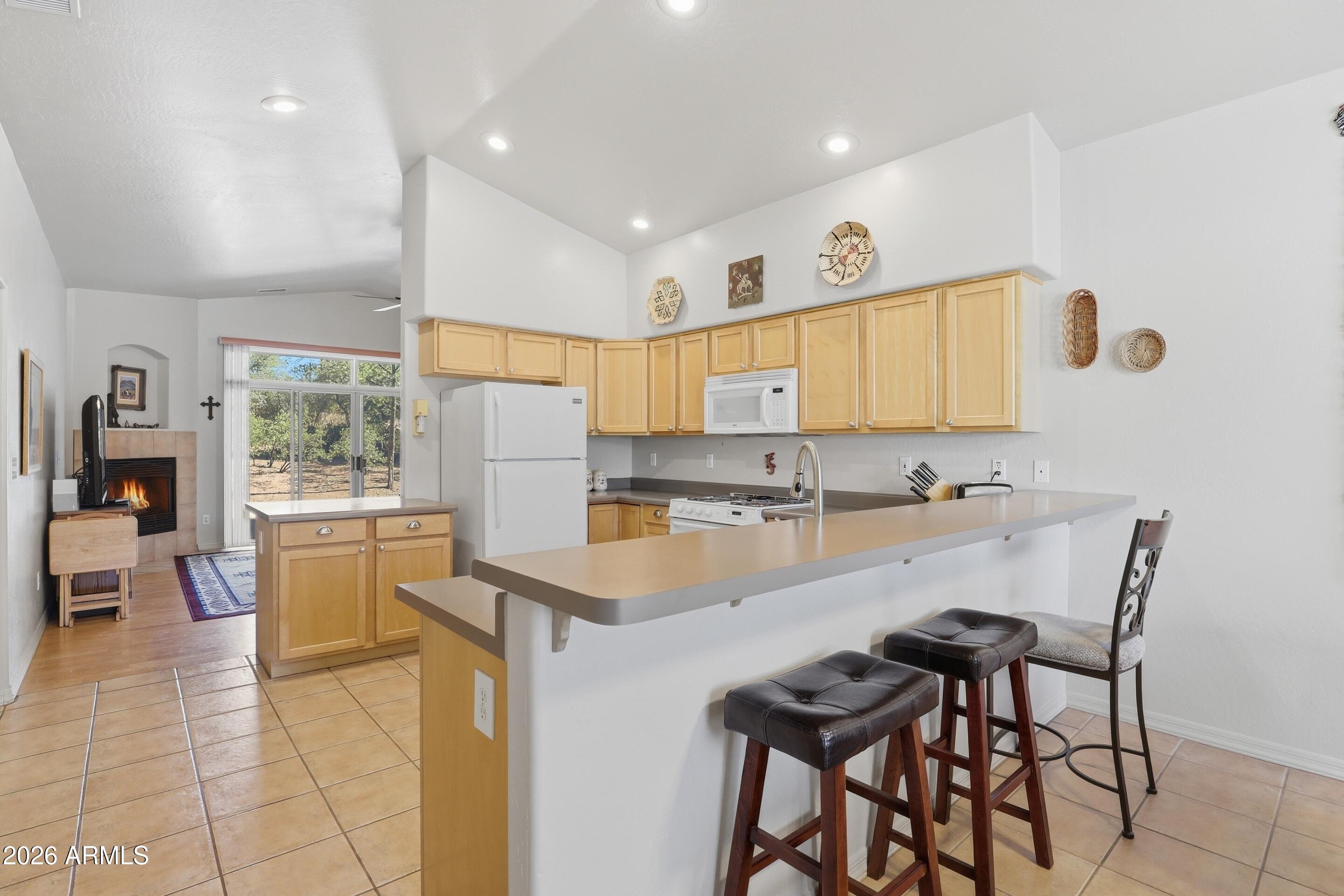 505 North Wood Hill Road Payson, AZ 85541 - Photo 8 of 26 a large kitchen with a table and chairs in it