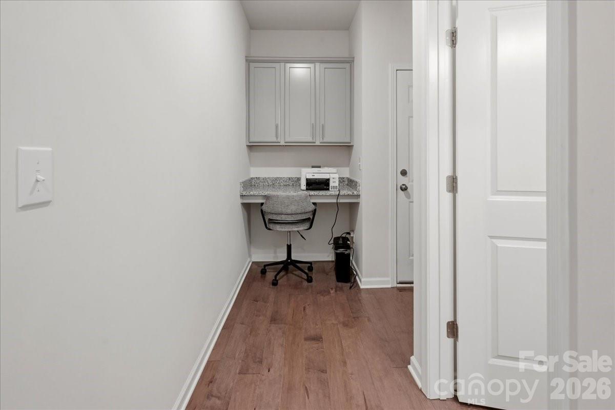 3001 Sterling Drive Waxhaw, NC 28173 - Photo 14 of 38 a view of a hallway with wooden floor and a bathroom