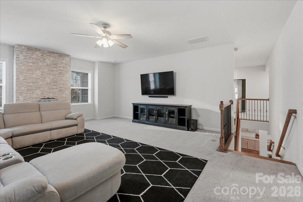 3001 Sterling Drive Waxhaw, NC 28173 - Photo 19 of 38 a living room with furniture a flat screen tv and a fireplace