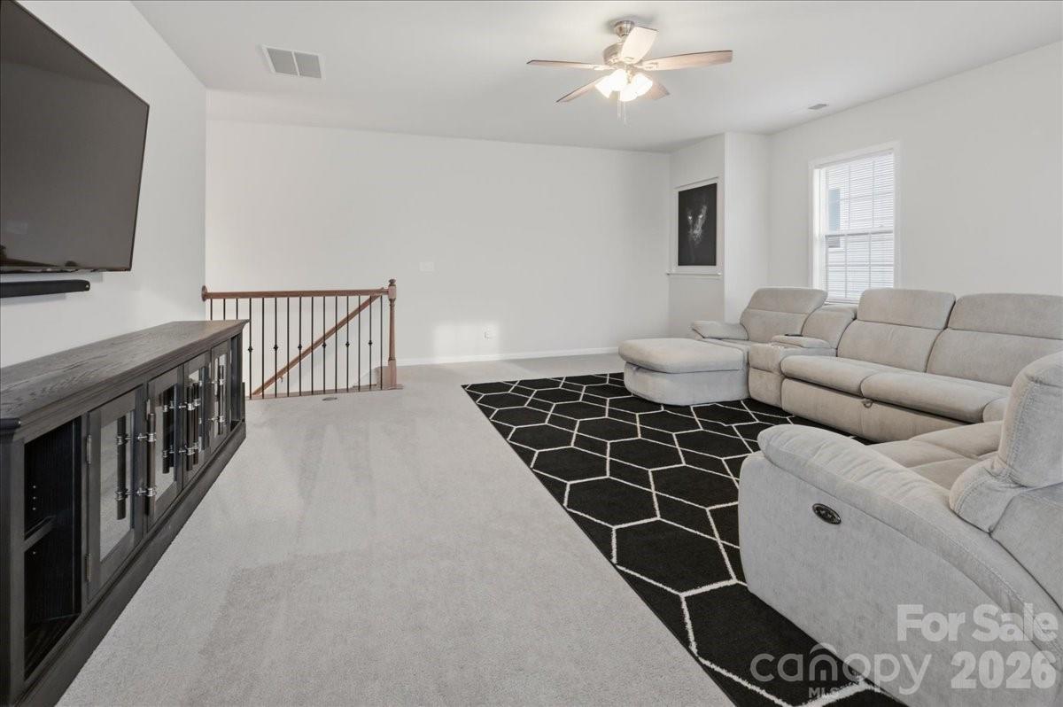 3001 Sterling Drive Waxhaw, NC 28173 - Photo 20 of 38 a living room with furniture a flat screen tv and a window