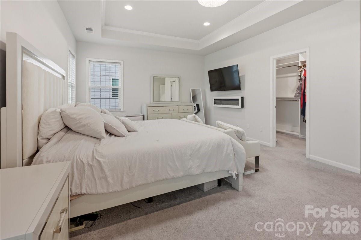 3001 Sterling Drive Waxhaw, NC 28173 - Photo 25 of 38 a bedroom with a bed and a flat screen tv