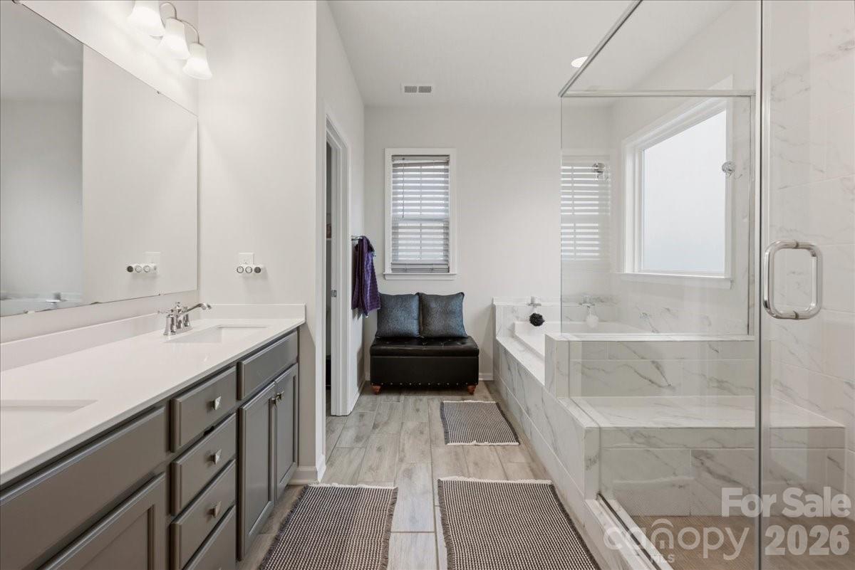 3001 Sterling Drive Waxhaw, NC 28173 - Photo 27 of 39 a spacious bathroom with a double vanity sink a mirror and a shower