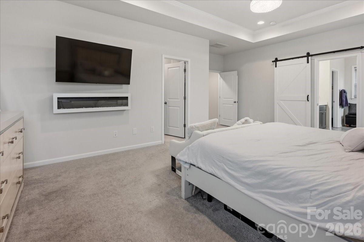 3001 Sterling Drive Waxhaw, NC 28173 - Photo 30 of 39 a spacious bedroom with a bed and a flat screen tv