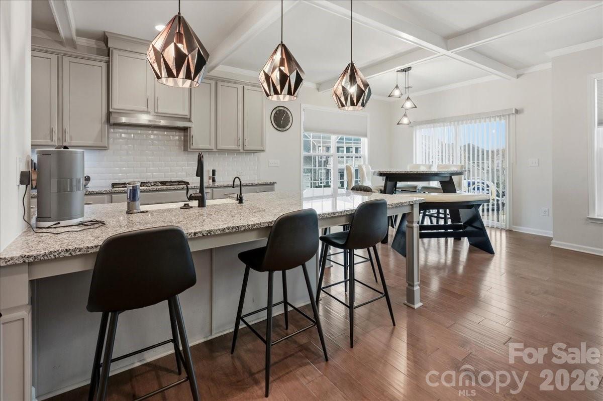 3001 Sterling Drive Waxhaw, NC 28173 - Photo 5 of 39 a kitchen with stainless steel appliances granite countertop a stove top oven a sink a dining table and chairs with wooden floor