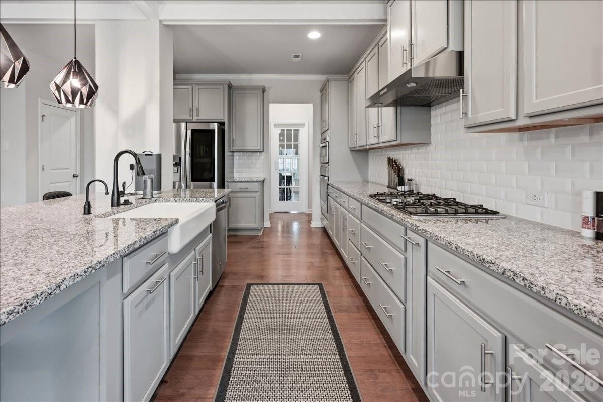 3001 Sterling Drive Waxhaw, NC 28173 - Photo 7 of 39 a kitchen with stainless steel appliances granite countertop a sink stove and cabinets