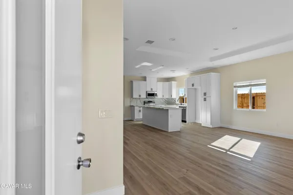 an empty room with a window and wooden floor