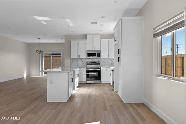 a kitchen with granite countertop a sink and a stove top oven