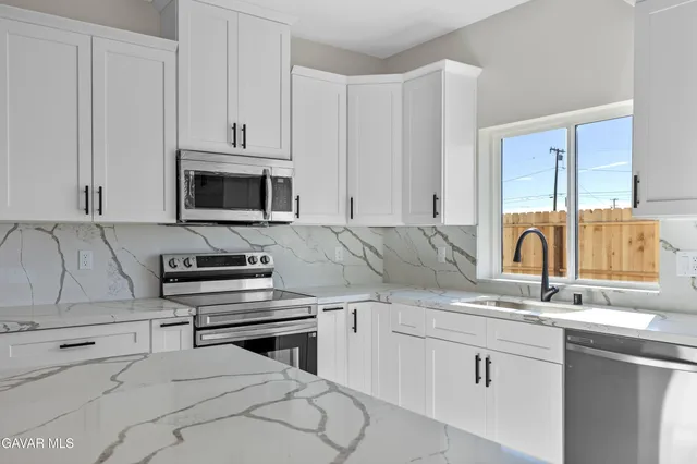 an empty room with a window and wooden floor