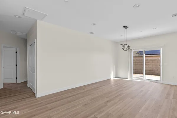 a view of a kitchen with furniture and wooden floor