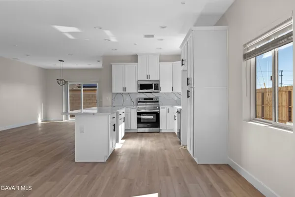 a kitchen with granite countertop a sink and a stove top oven