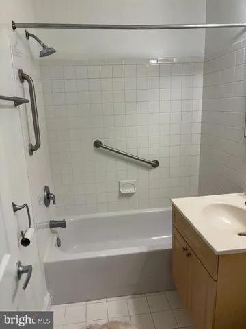 a bathroom with a bathtub a shower and a sink