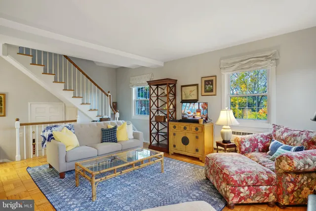 a living room with furniture fireplace and a window