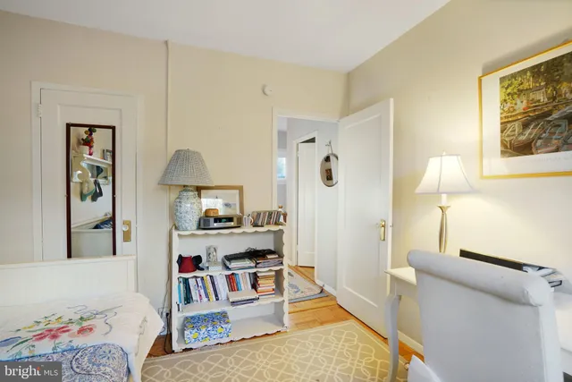 a living room with furniture and a baby crib