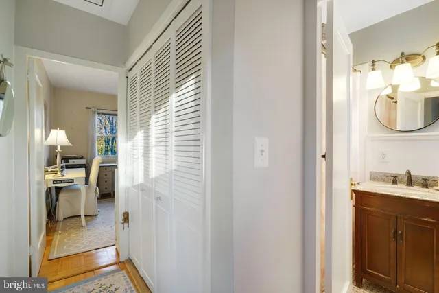 a bathroom with a sink a mirror and a window