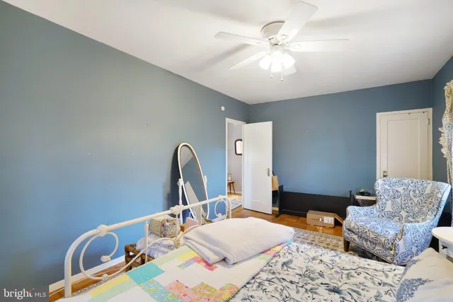 a bedroom with a bed a couch and dresser