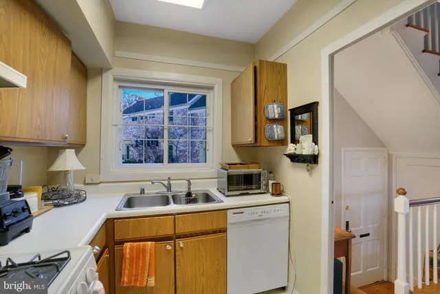 a kitchen with stainless steel appliances a sink stove and cabinets