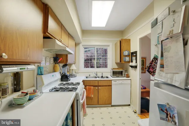 a kitchen with a stove a sink and a refrigerator