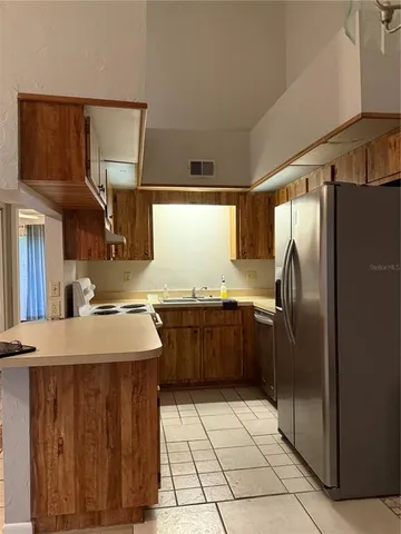 a view of a livingroom with wooden cabinets