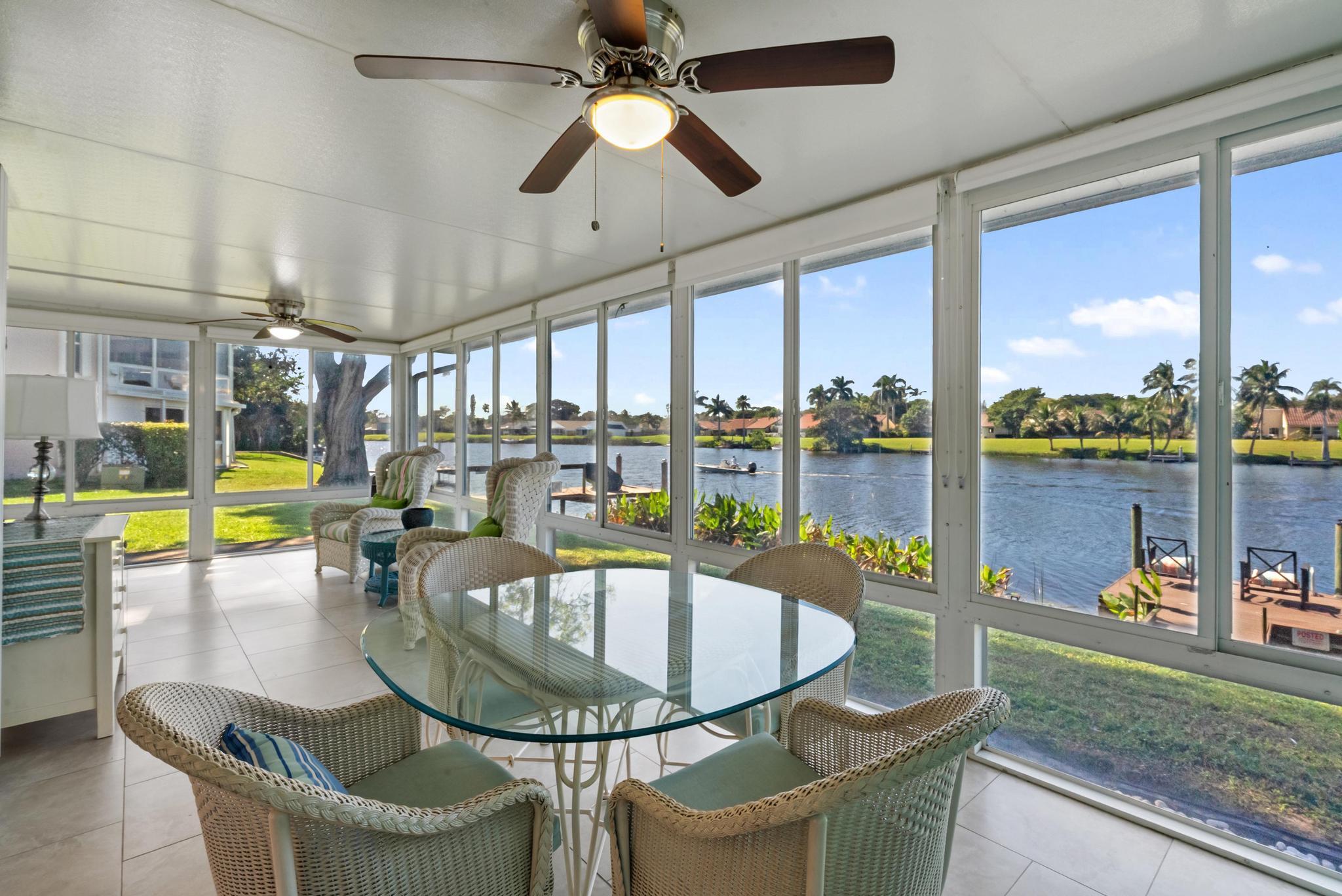 a dining room with furniture and a floor to ceiling window