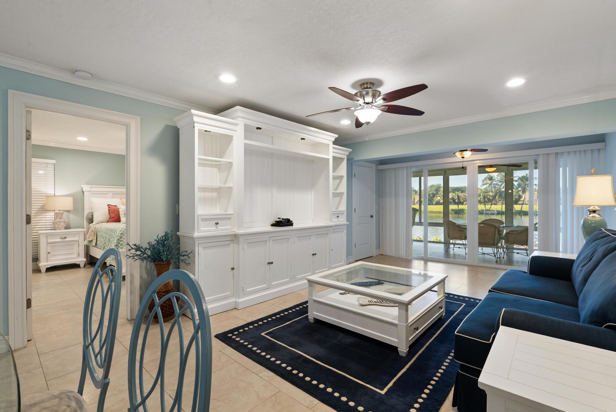 1280 Northwest 20th Avenue, Unit 101 Delray Beach, FL 33445 - Photo 11 of 31 a living room with furniture fireplace and a large window