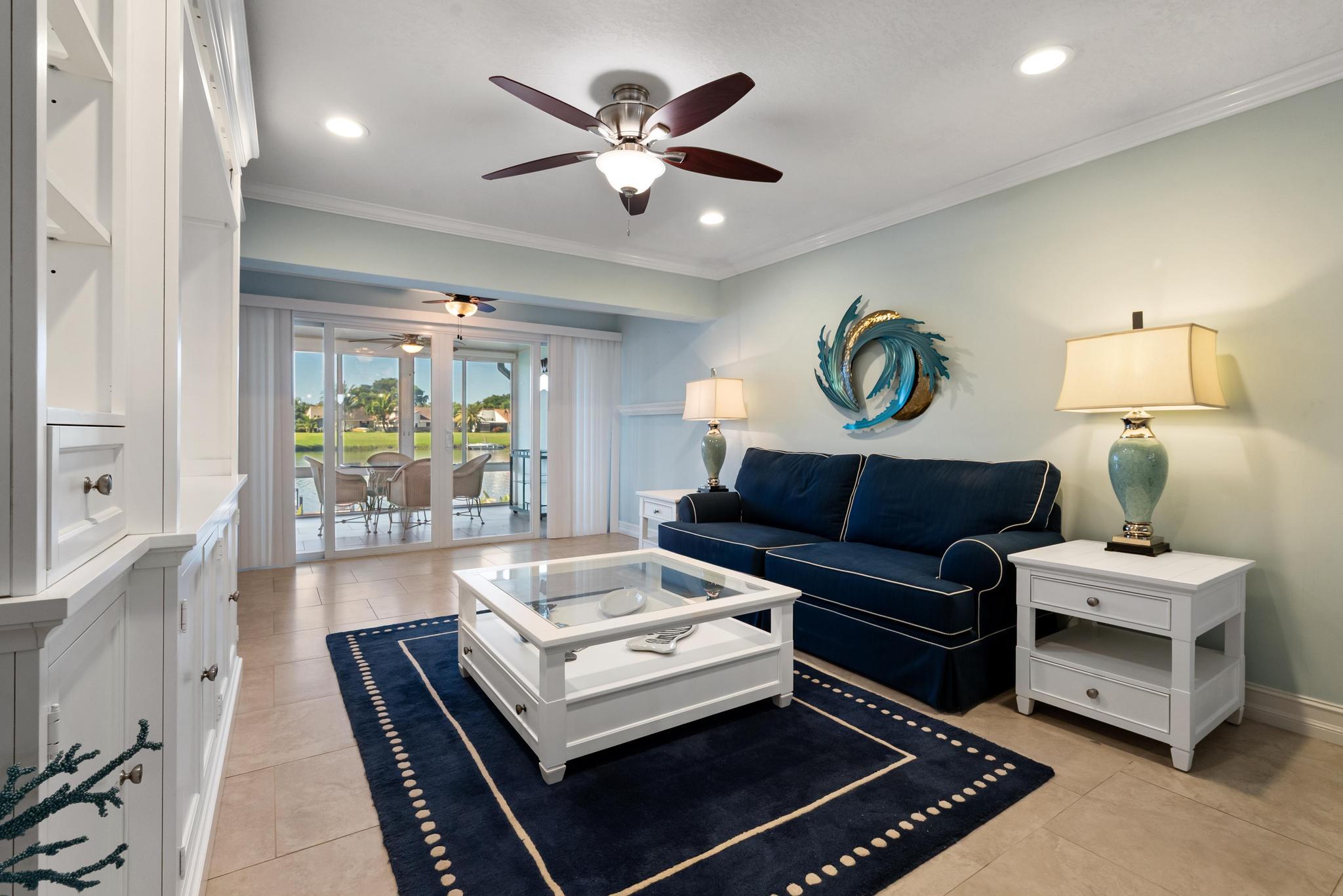 1280 Northwest 20th Avenue, Unit 101 Delray Beach, FL 33445 - Photo 15 of 31 a living room with furniture and a table