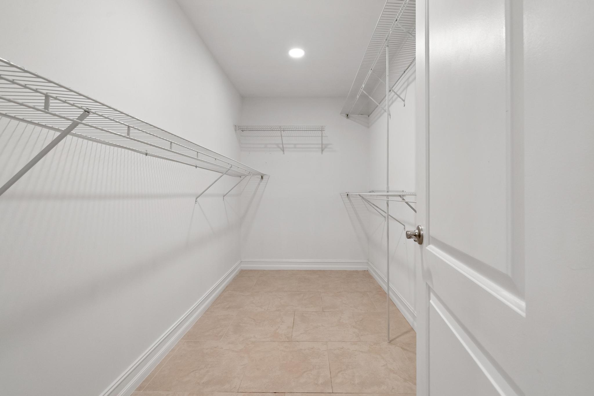 1280 Northwest 20th Avenue, Unit 101 Delray Beach, FL 33445 - Photo 21 of 31 a view of a room with racks on the wall