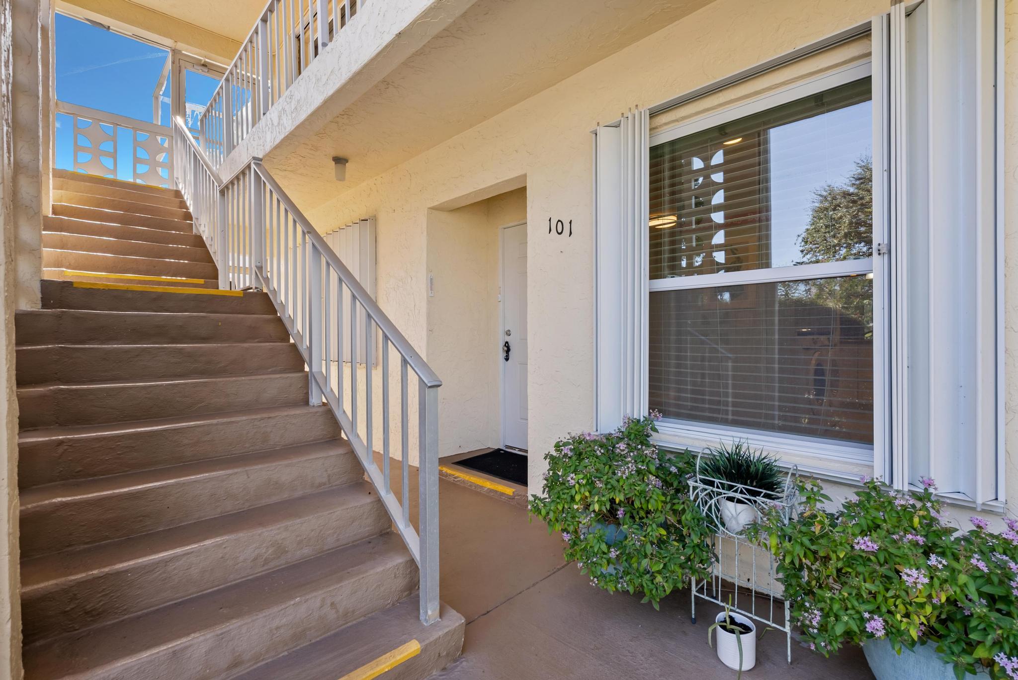 1280 Northwest 20th Avenue, Unit 101 Delray Beach, FL 33445 - Photo 28 of 31 a view of staircase with wooden floor and a potted plant