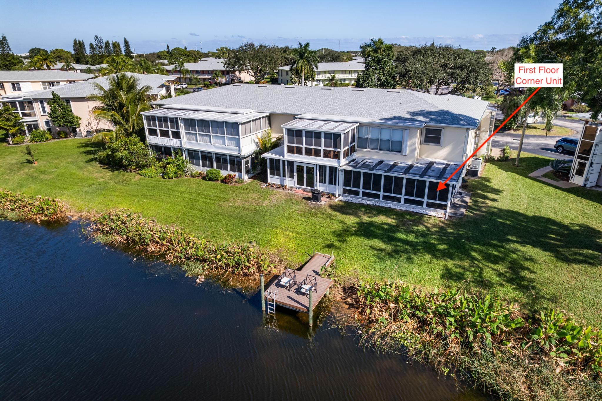 1280 Northwest 20th Avenue, Unit 101 Delray Beach, FL 33445 - Photo 3 of 31 an aerial view of a house with a garden and lake view
