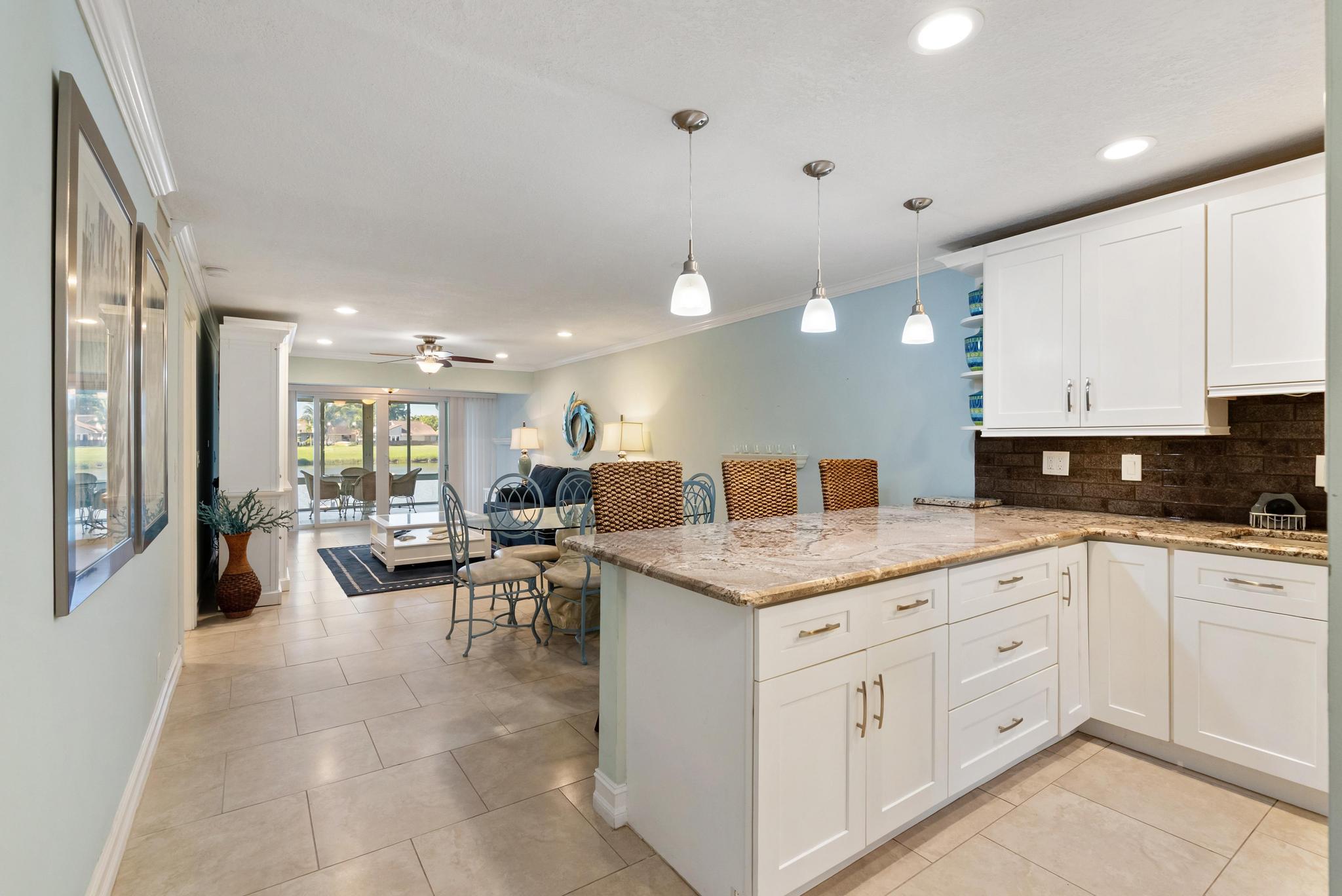 1280 Northwest 20th Avenue, Unit 101 Delray Beach, FL 33445 - Photo 6 of 31 a large white kitchen with a large window