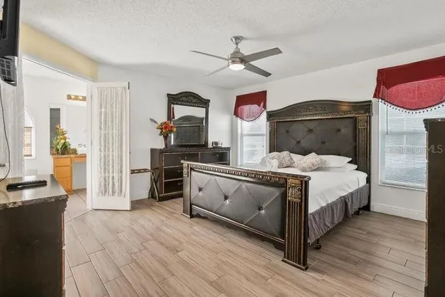 a large bedroom with a bed and a chandelier