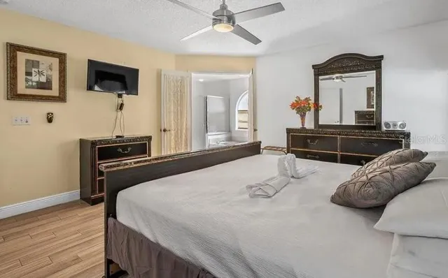 a bedroom with a bed and a flat screen tv