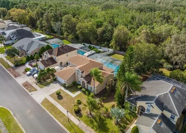 an aerial view of residential houses with outdoor space