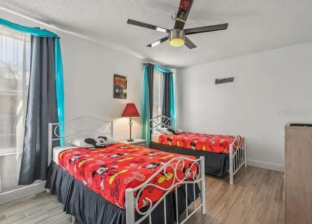 a bedroom with a bed and a chandelier