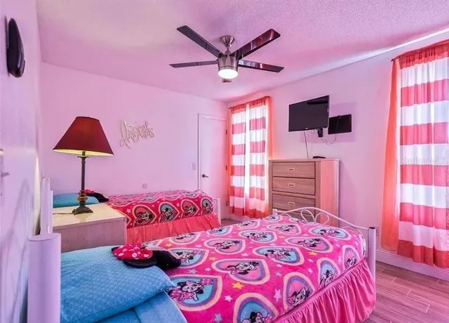 a bedroom with a bed and a flat screen tv