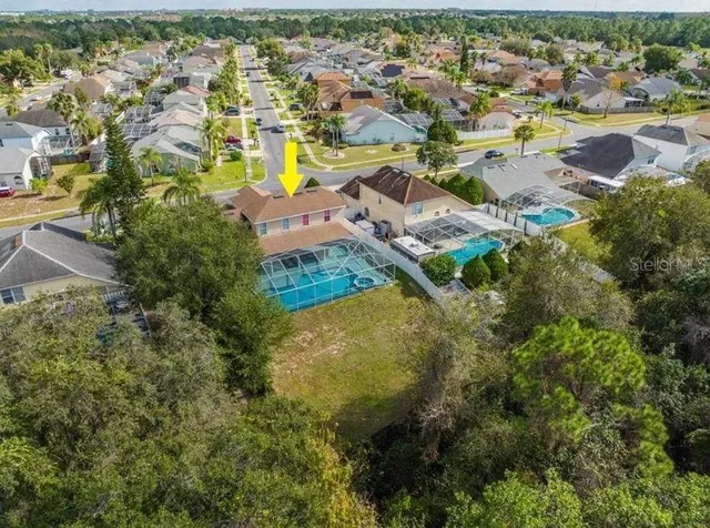 an aerial view of residential houses with outdoor space