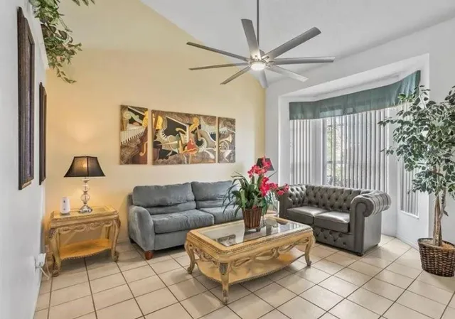 a living room with furniture and a large window