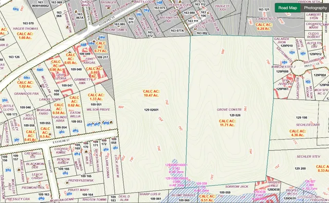 an aerial view of a city with lots of residential buildings and mountain view in back