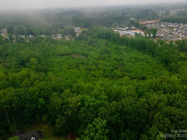 an aerial view of houses with yard