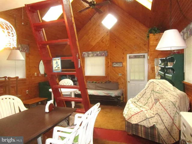 a living room with furniture and a lamp