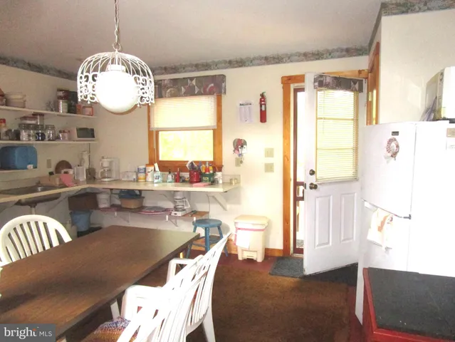 a living room with dining table and a large window