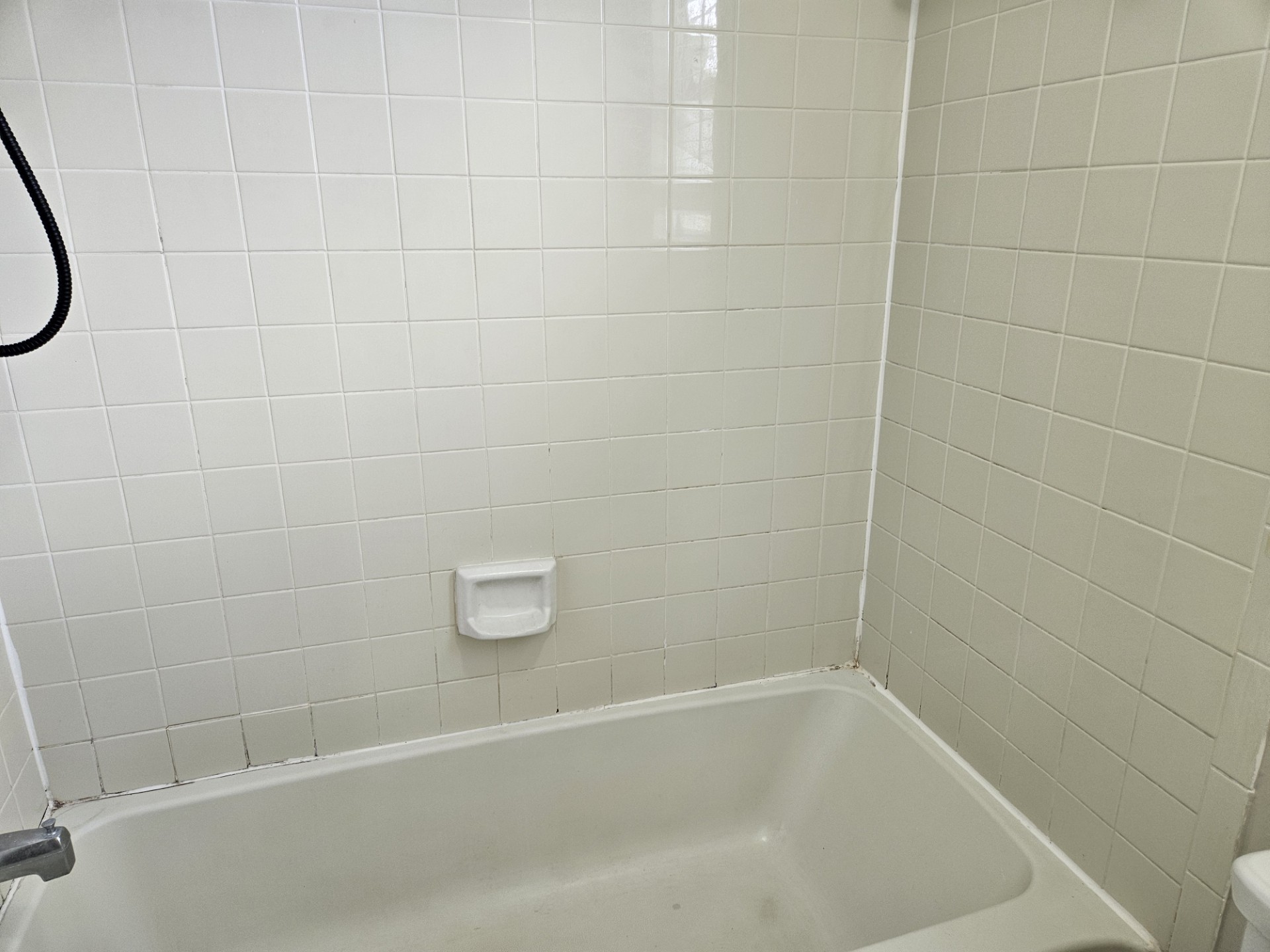 805 Lexington Road, Unit B Elgin, TX 78621 - Photo 7 of 11 A well-maintained bathroom with a tiled shower-tub combination awaits your daily refresh.