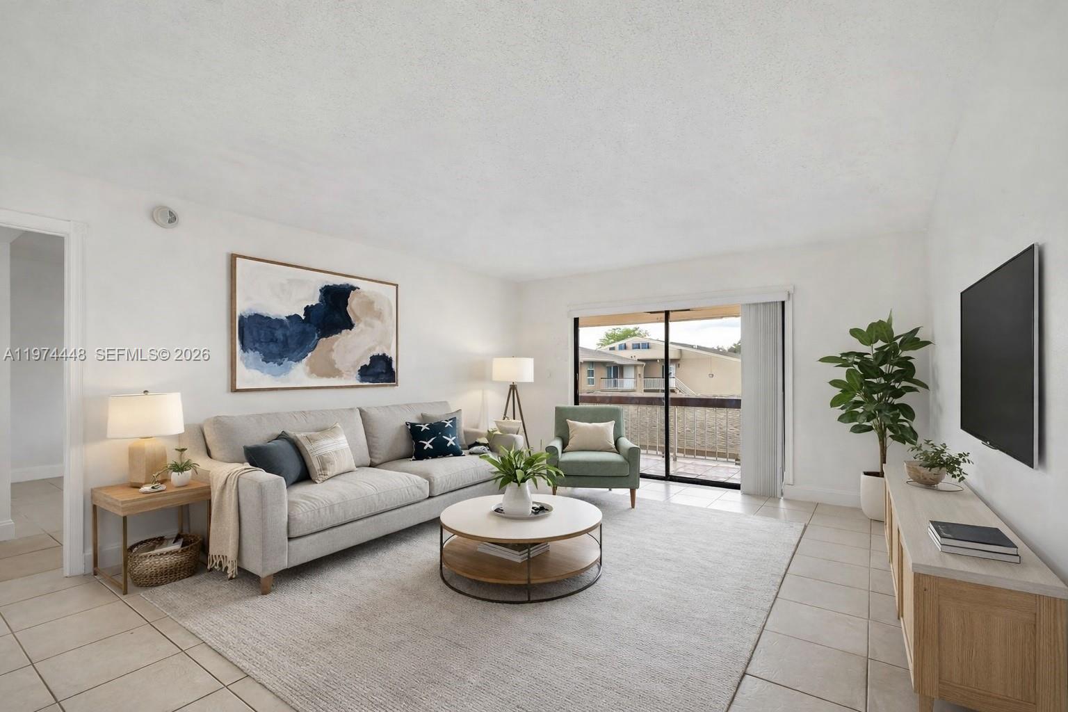 13787 Southwest 66th Street, Unit 254D Miami, FL 33183 - Photo 1 of 18 a living room with furniture and a flat screen tv