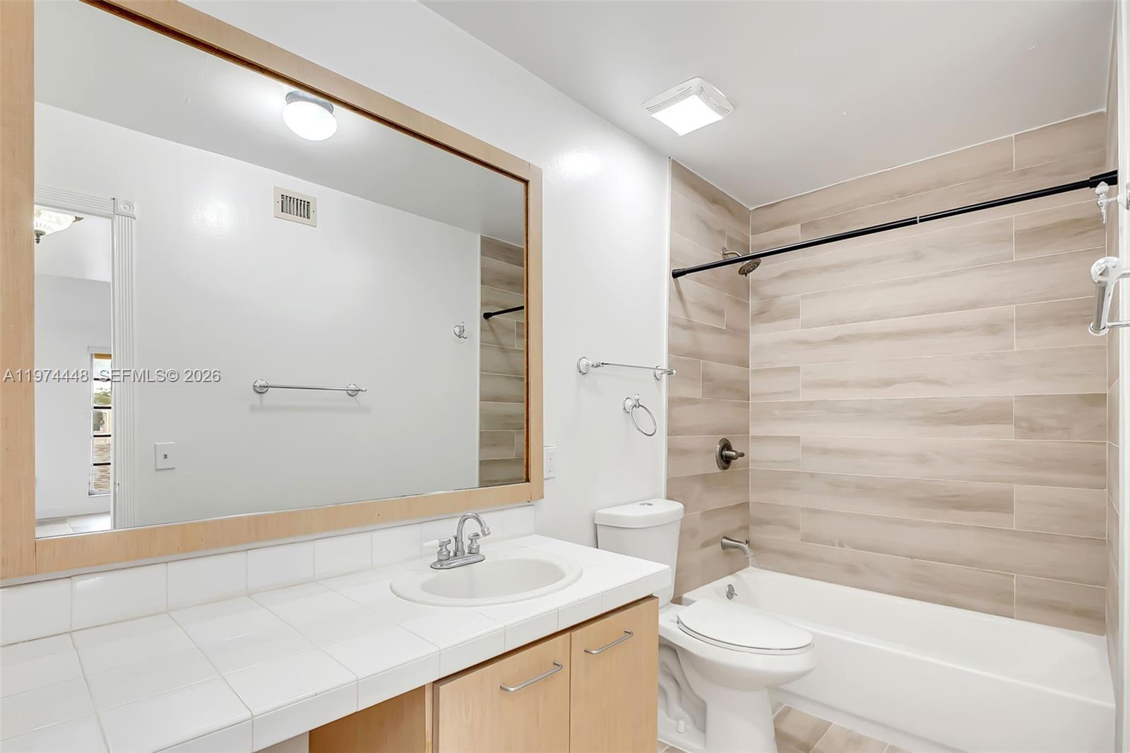 13787 Southwest 66th Street, Unit 254D Miami, FL 33183 - Photo 11 of 18 a bathroom with a sink a toilet and shower
