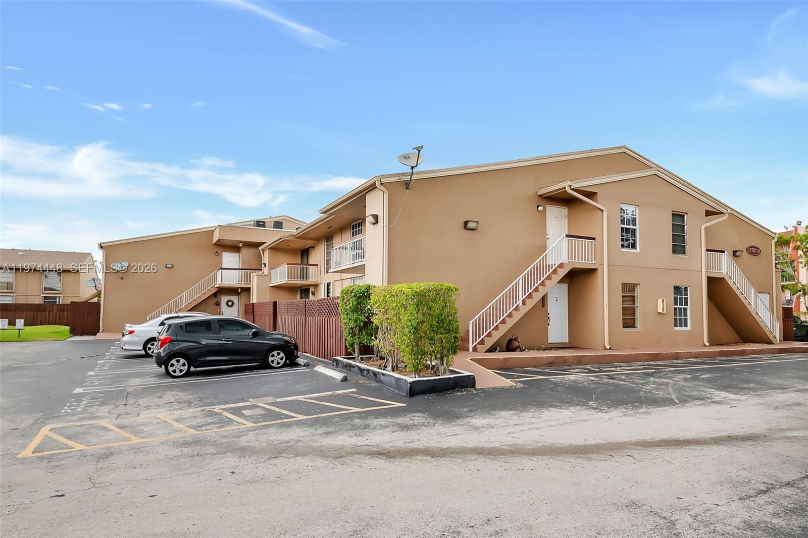 13787 Southwest 66th Street, Unit 254D Miami, FL 33183 - Photo 16 of 18 a car parked in front of a house