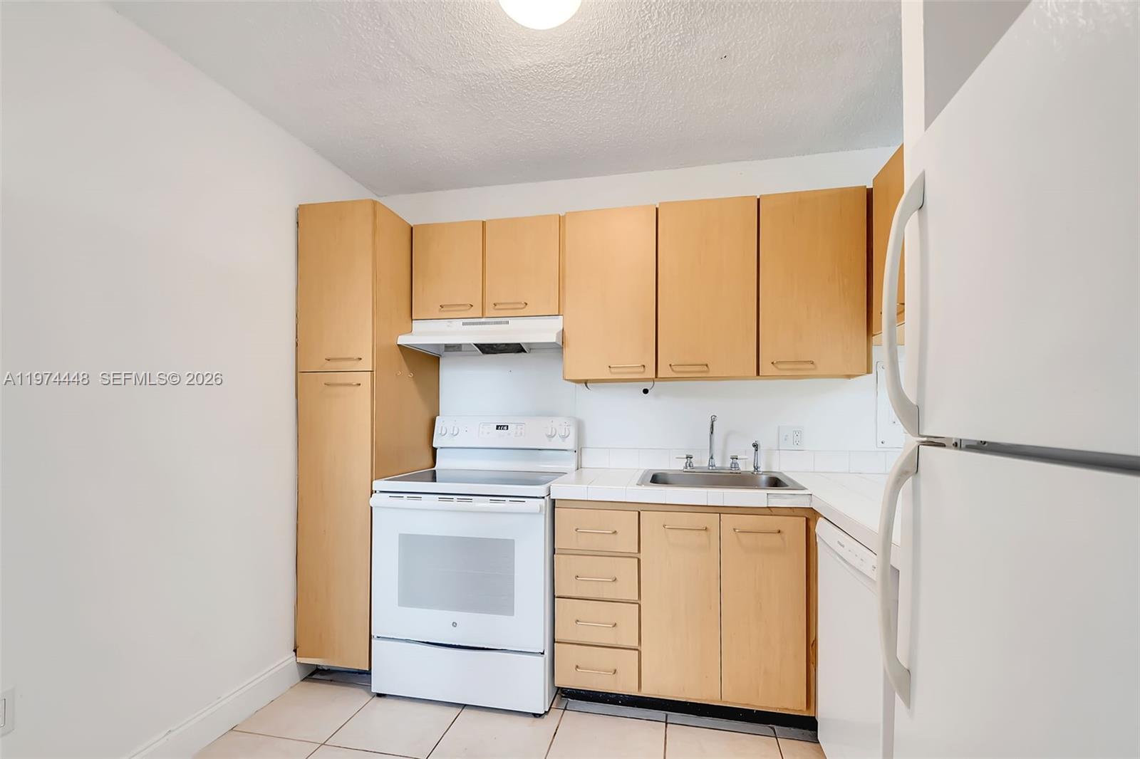 13787 Southwest 66th Street, Unit 254D Miami, FL 33183 - Photo 9 of 18 a kitchen with a sink cabinets and a window