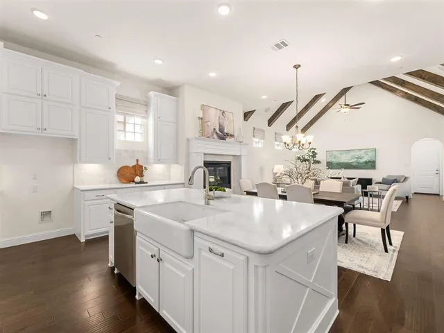 a open kitchen with sink a stove and chairs