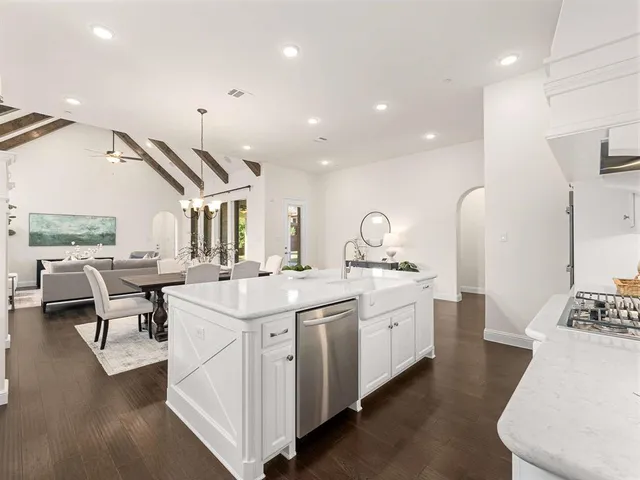 a large white kitchen with a large window
