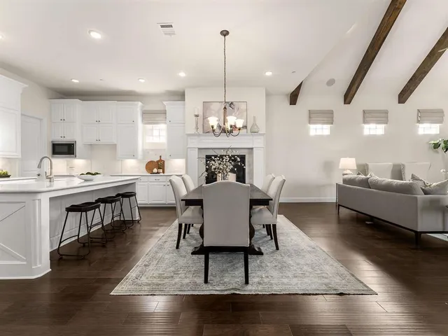 a living room with dining room and kitchen view